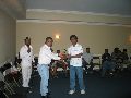 Flyod Campbell ( Minneapolis Cricket club) presenting the trophy to sandeep (NDSU)
